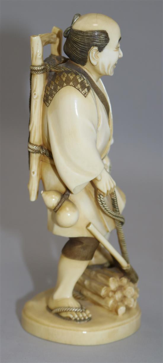 A Japanese ivory figure of a woodsman, early 20th century, 18cm